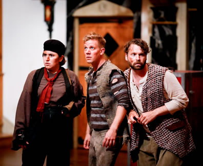 PRentis in brown shirt, black coveralls, red scarf tied around neck and black hat, Peter in holey blue and gray striped shirt, filthy pants and burlap fest, and Ted in grungy white shirt, checkered rug as an oversized vest, green workpants look warily about.